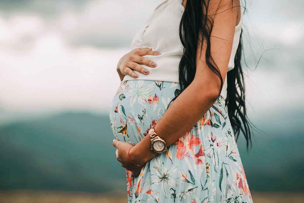 Pregnant lady holding belly. Free public domain CC0 photo.