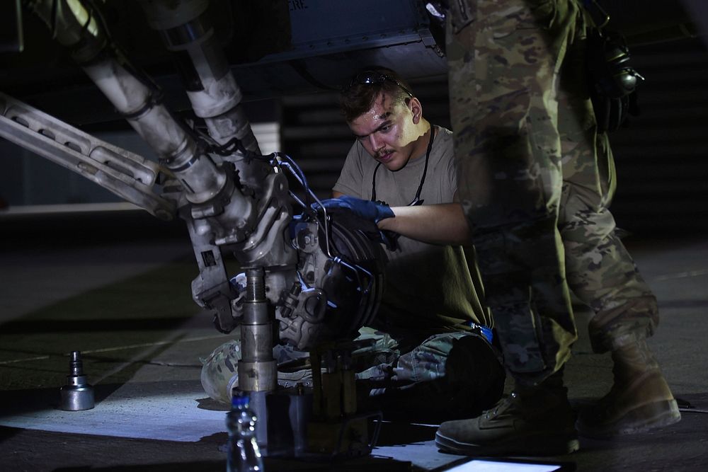 Senior Airman Connor Stuart, 157th Expeditionary Fighter Squadron crew chief, performs a tire change on an F-16 Fighting…