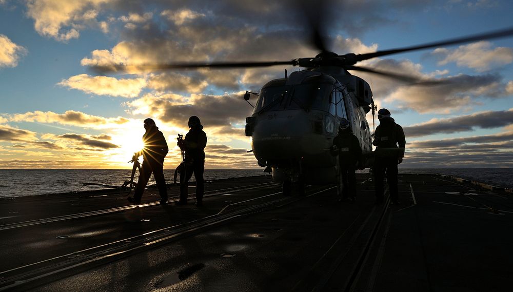 The British Royal Navy Type 23 frigate HMS Northumberland's embarked Merlin Mk2 helicopter operates from the deck of the…