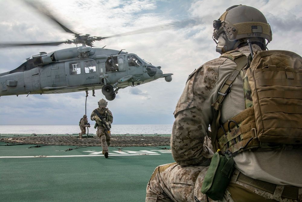 U.S. Sailors assigned to Explosive Ordnance Disposal Unit (EODMU) 5 fast rope from an MH-60S Sea Hawk helicopter assigned to…