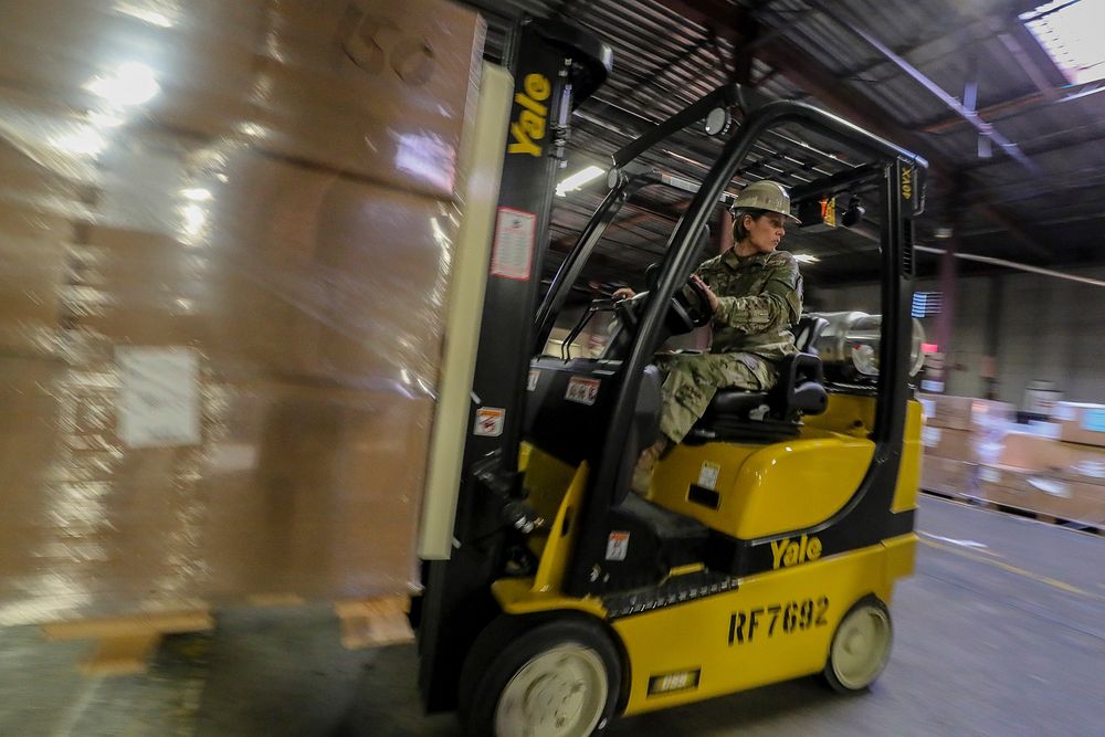 U.S. Army Staff Sgt. Amber Knickman, a Supply Specialist with the New Jersey Army National Guard, moves pallets of gear…