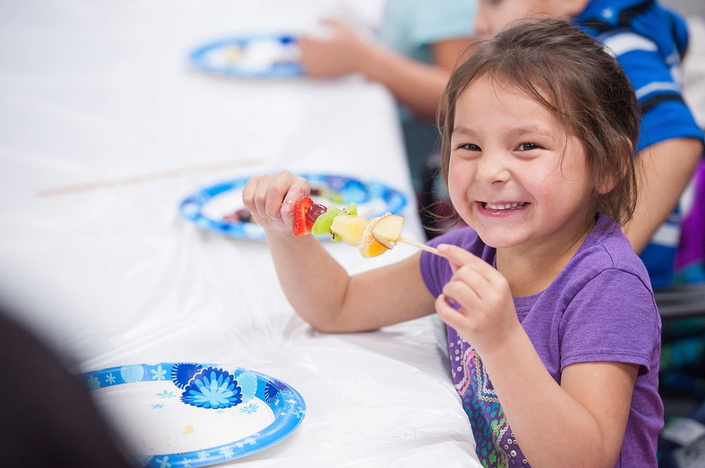 Children learn how to make fruit kebabs at the Spirit Lake Food Distribution Program located on the Spirit Lake reservation…
