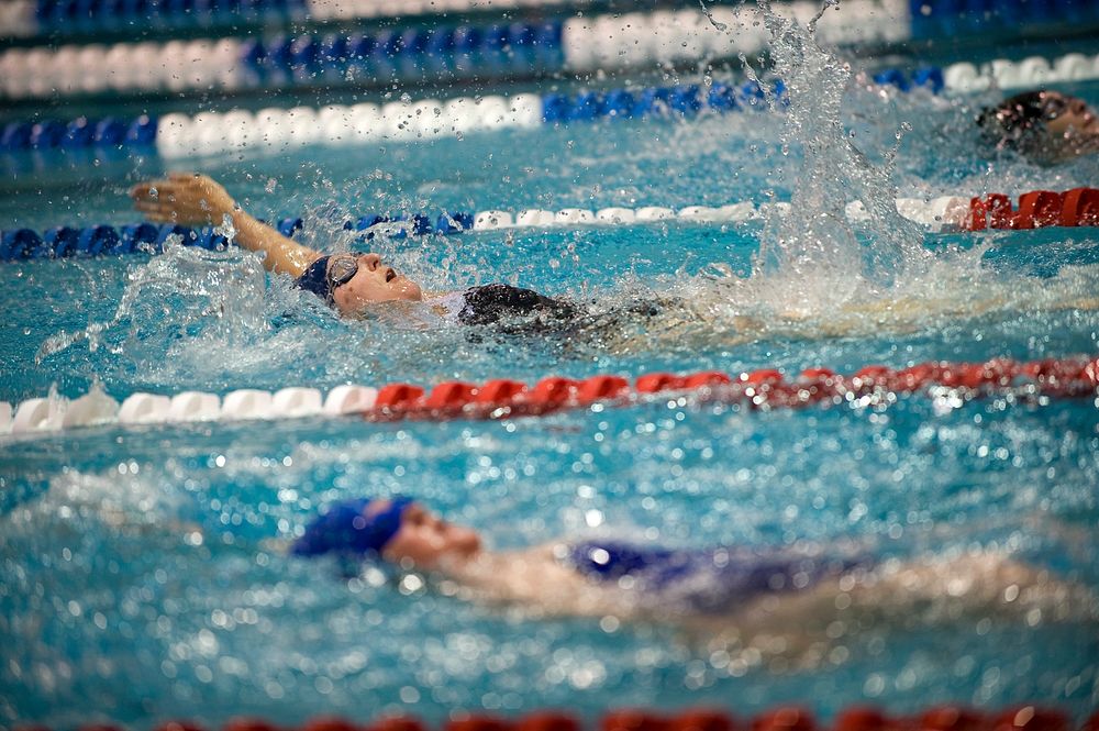 U.S. Navy Lt. Melanie Monts de Oca pulls ahead of the competition during a preliminary swimming event for the inaugural…