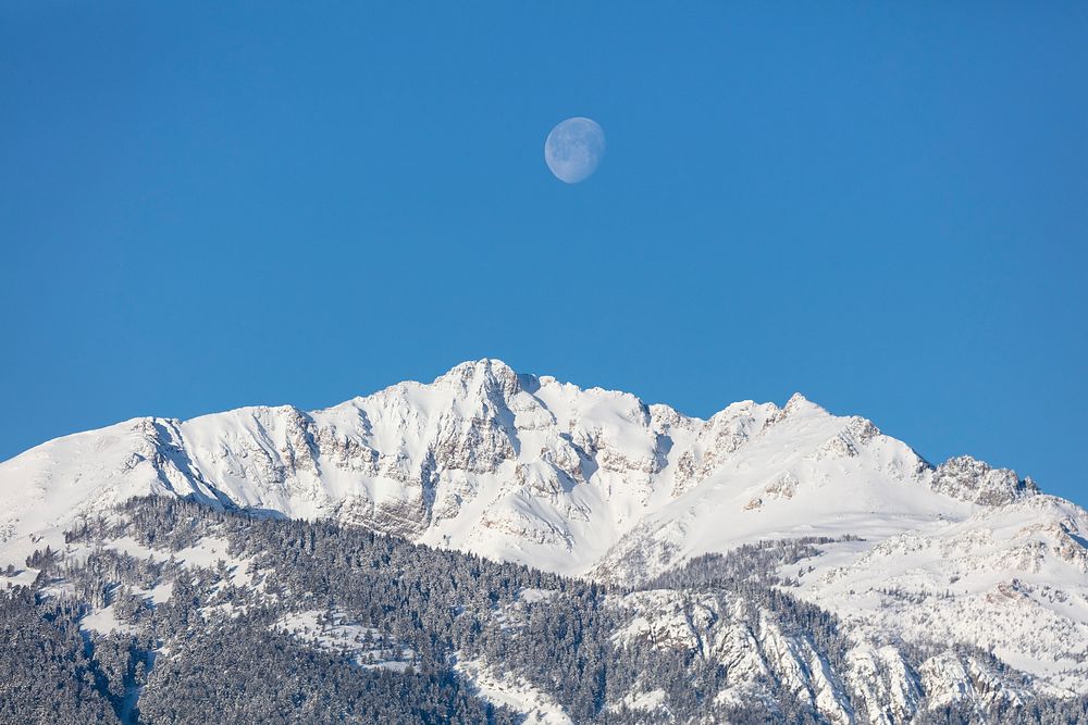 The moon above Electric peak after a winter storm. Original public domain image from Flickr