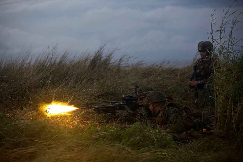 Marines with Charlie Company, Battalion Landing Team, 1st Battalion, 4th Marines, fire at a notional enemy force using blank…