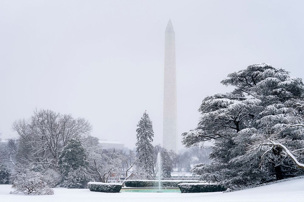 The South Lawn of the White House looking toward the Washington Monument is seen covered in snow. Original public domain…