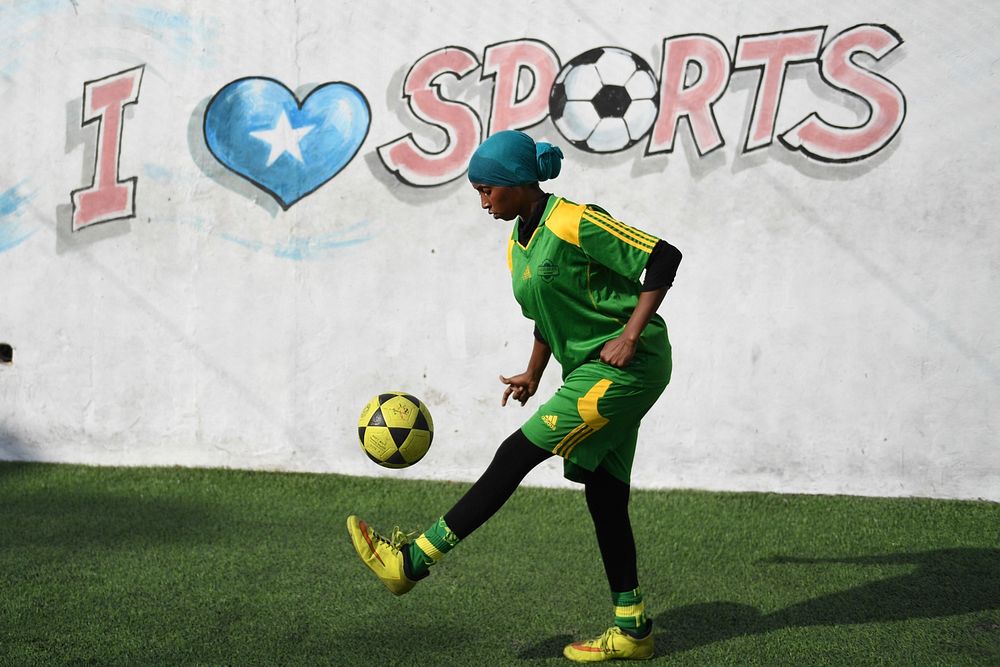 A female soccer player dribbles a ball during a training session for Golden Girls Football Club in Mogadishu, Somalia on…