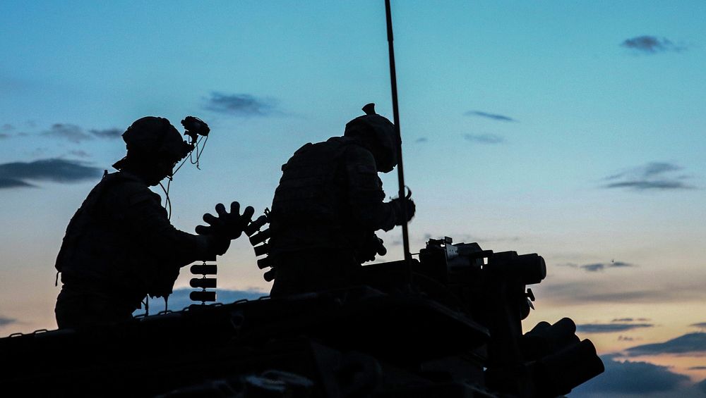 U.S. Soldiers from Alpha Company, 1st Battalion, 111th Infantry, 56th Stryker Brigade Combat Team prepare rounds while…