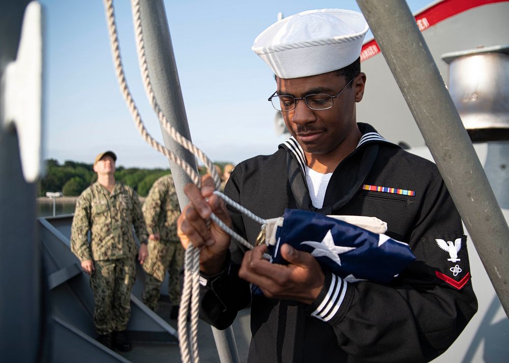 Electronics Technician 3rd Class Devaughnta Bodiford prepares to raise the Union Jack aboard the Blue Ridge-class command…