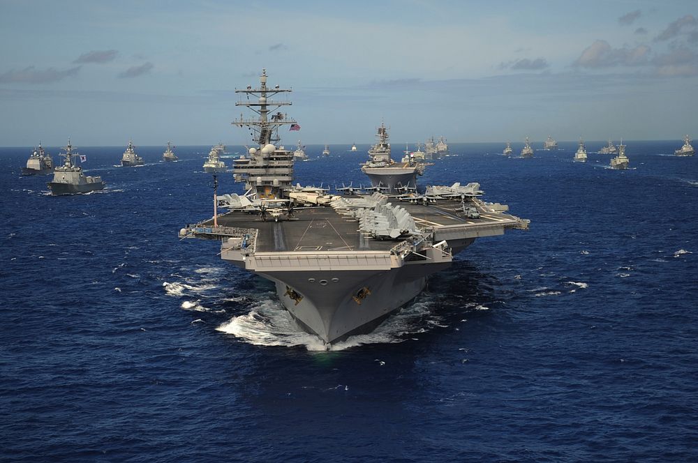 The Nimitz-class aircraft carrier USS Ronald Reagan (CVN 76) leads a mass formation of ships from Korea, Taiwan, Japan…