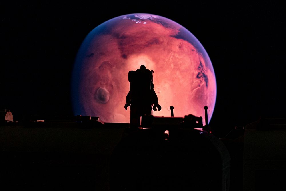Pink earth with astronaut silhouette. Original public domain image from Flickr