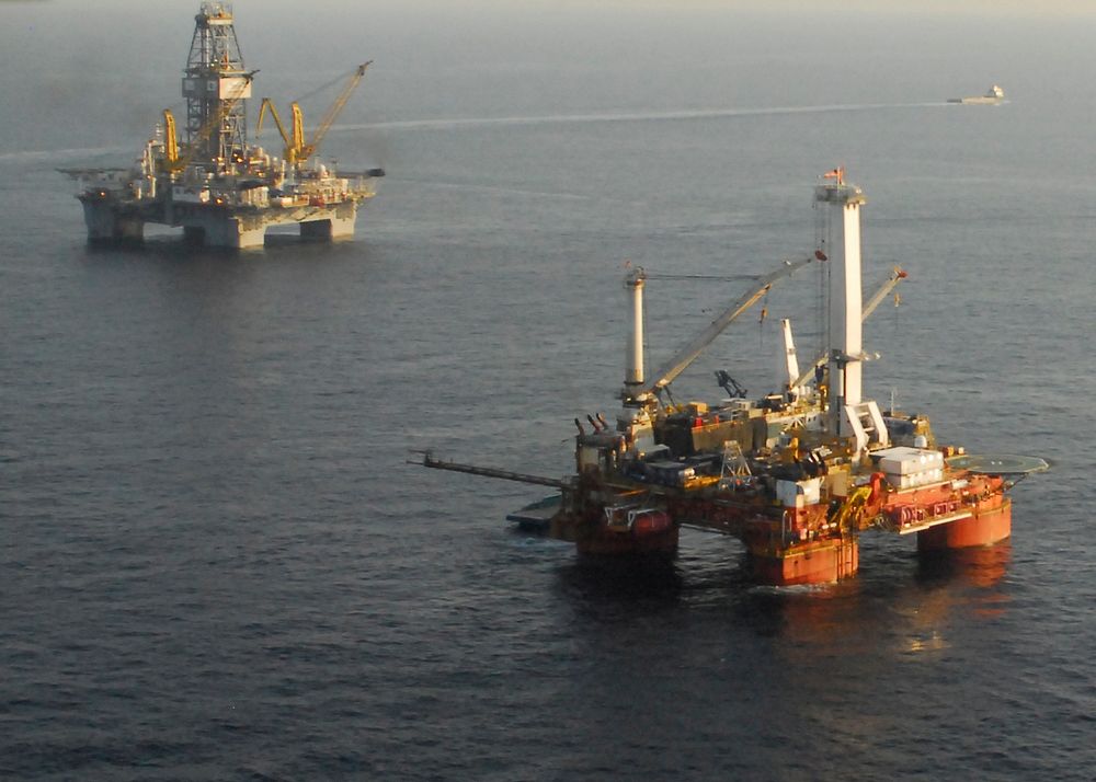Rigs drilling a relief well and preparing the static kill are shown in the Gulf of Mexico July 31, 2010, over the Deepwater…