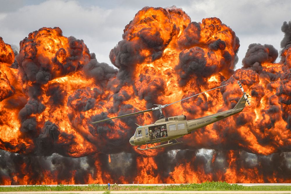 A Bell UH-1 Iroquois Helicopter, nicknamed the &ldquo;Huey&rdquo;, takes off amidst an explosion during a reenactment of a…