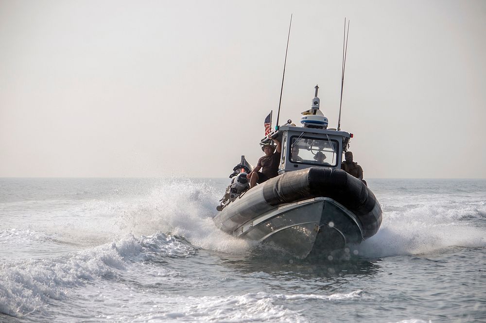 U.S. Navy Sailors assigned to Explosive Ordnance Disposal Mobile Unit (EODMU) 1 operate a rigid-hull inflatable boat while…