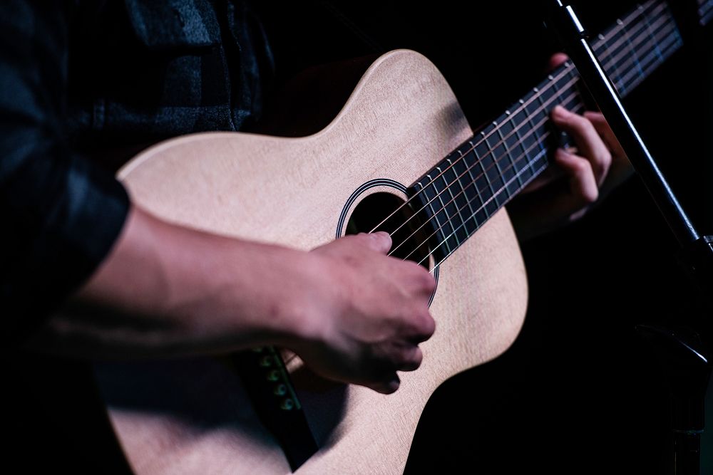 A man's hand playing guitar. Original public domain image from Flickr