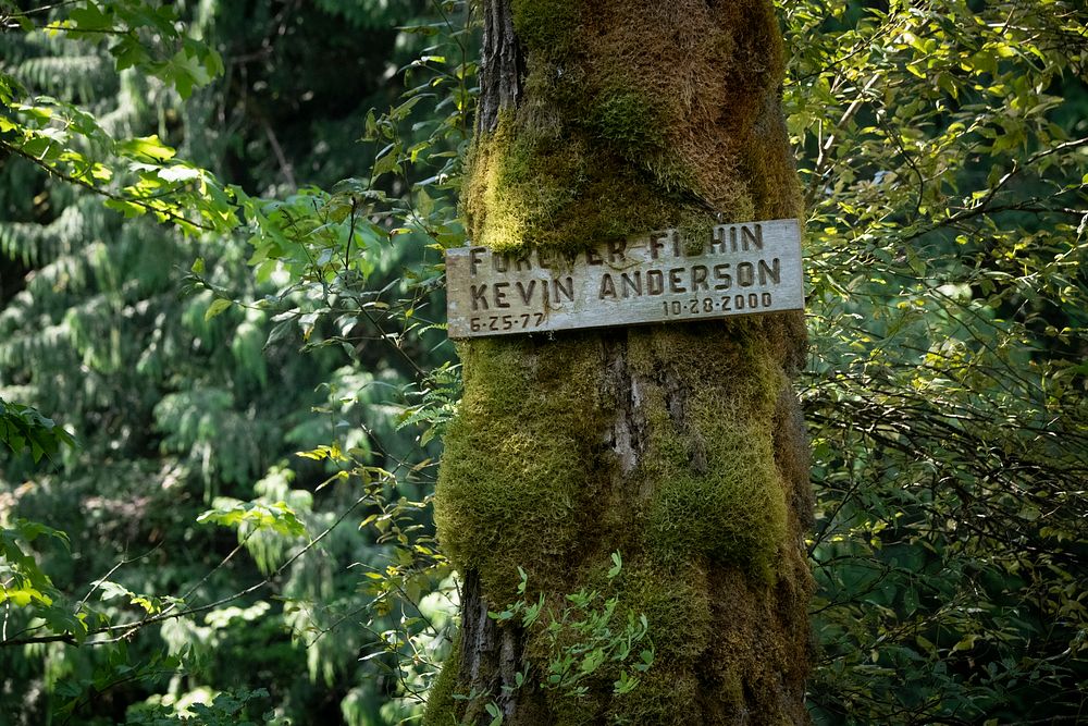 A sign memorializes fisherman Kevin Anderson, along a trail to the Skookum Hole, near the Lummi Skookum Fish Hatchery along…