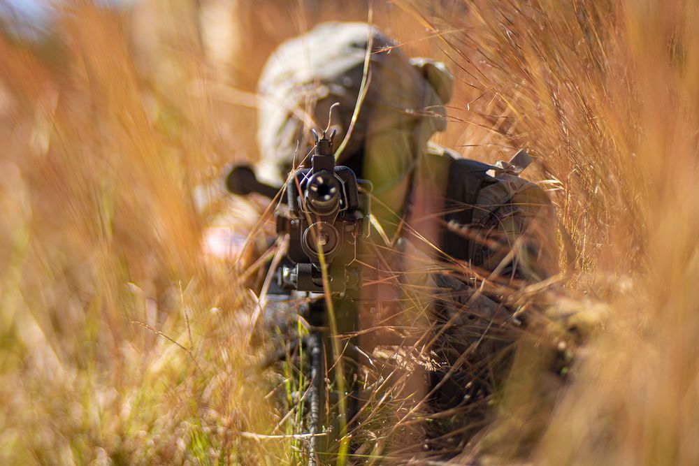 Army solider shooting gun. Original public domain image from Flickr