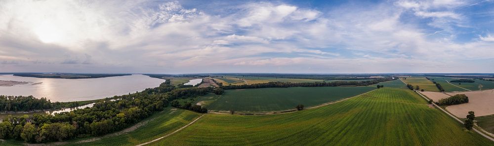 180 degree spherical aerial panorama of the Mississippi River flows in the foreground and it is not uncommon to see water…