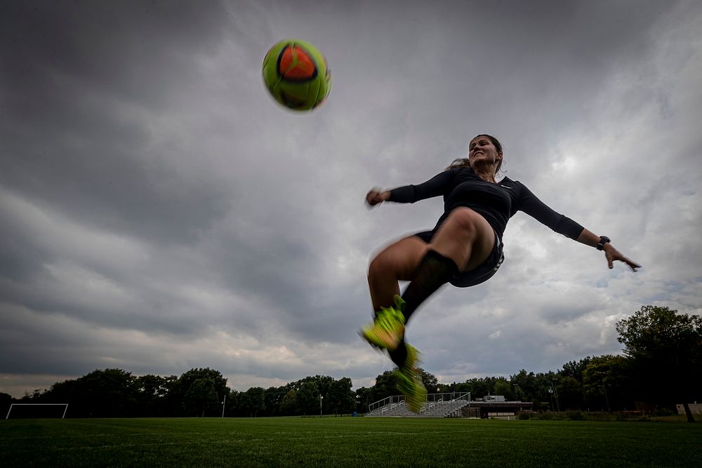 U.S. Army Sgt. Georgia Varoucha, a Recruiter with the New Jersey National Guard, kicks a soccer ball while practicing in…