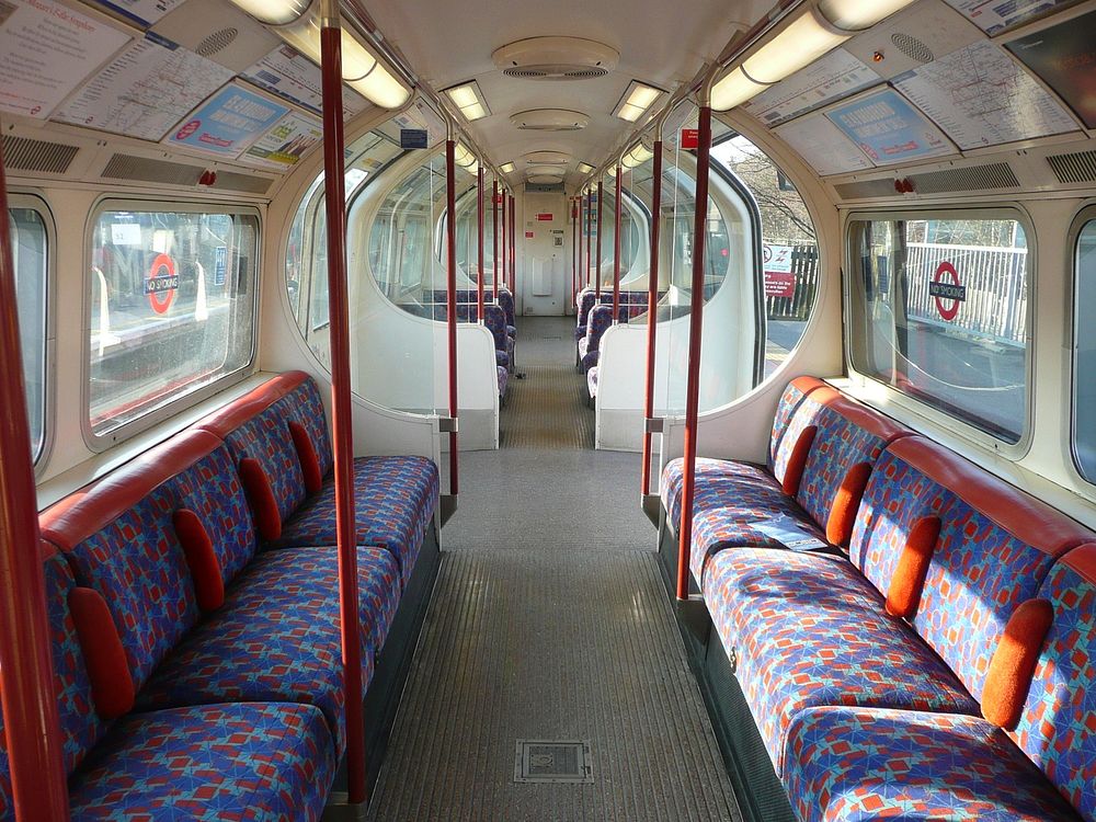 Inside a Bakerloo line 1972 tube stock train (probably at Stonebridge Park station) which has the seat fabric design that…