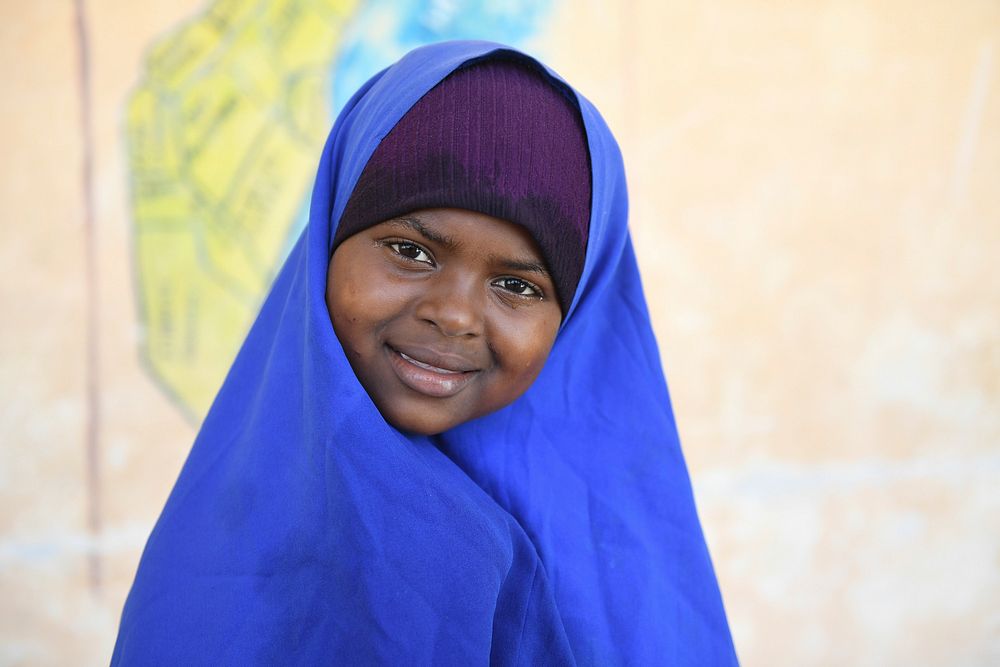 A grade one student poses for a photograph during break time outside of her class at Mohamud Hilowle Primary and Secondary…