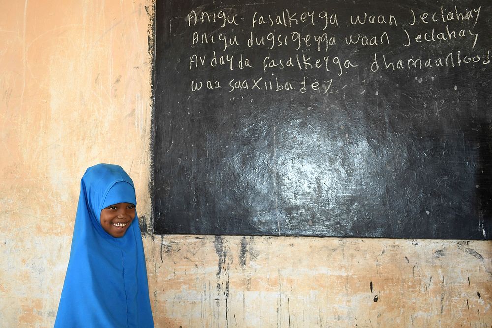 A grade one student reads a lesson on the blackboard at Mohamud Hilowle Primary and Secondary School during a class in…