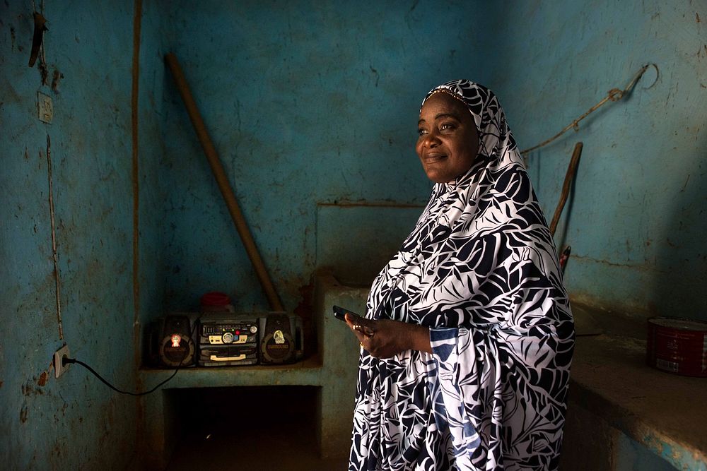 Zeinabou Karidou, a presenter at Radio Baarou, listens to a live round table broadcast in Radio Baarou’s office in Ouallam…