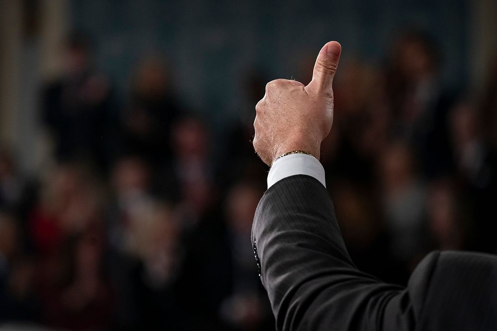 A member of Congress gives the thumbs-up, in the House chamber at the U.S. Capitol in Washington, D.C. Original public…