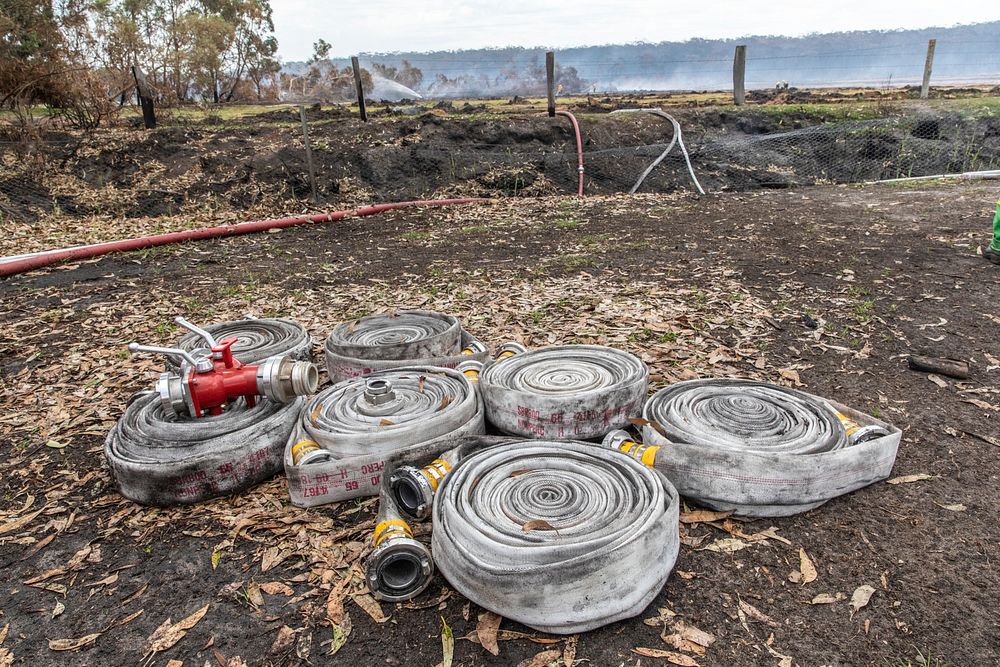 Rolled-up hoses stages for use on the Peat Fire near Cape Conran Coastal Park, Victoria, Australia. Original public domain…