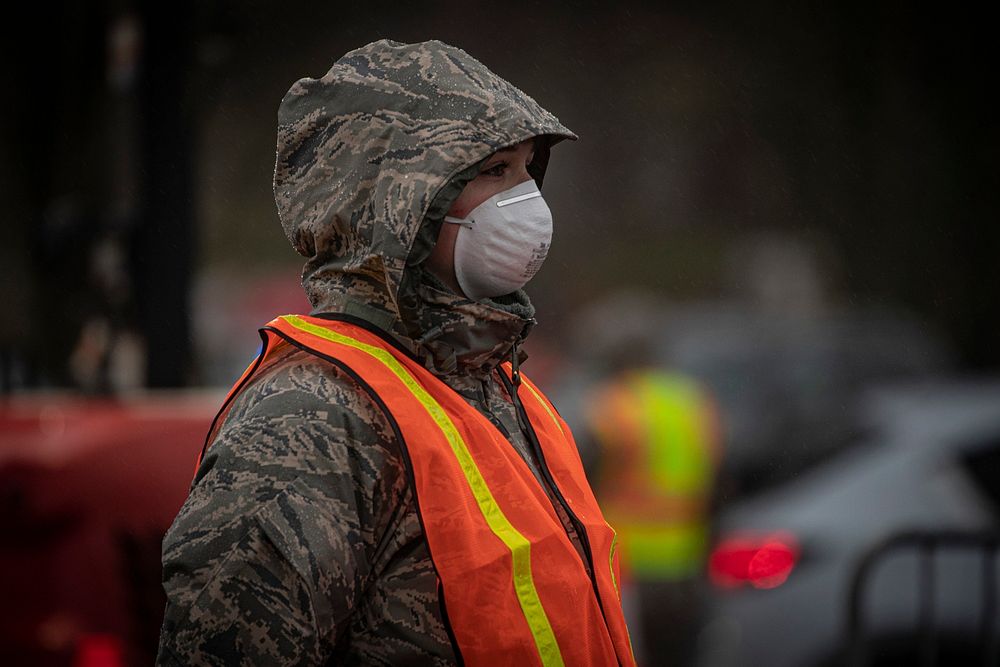 A New Jersey National Guard Airman directs traffic at a COVID-19 Community-Based Testing Site at the PNC Bank Arts Center in…