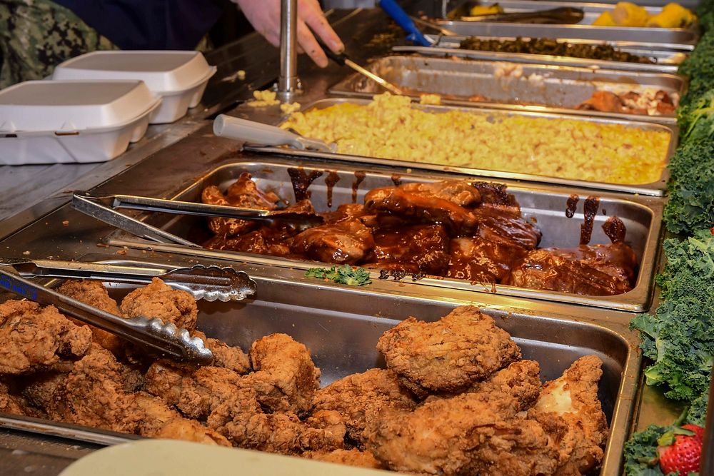 PORTSMOUTH, Va. (Feb. 26, 2020) Naval Medical Center Portsmouth's (NMCP) galley staff serves a cultural meal for the African…