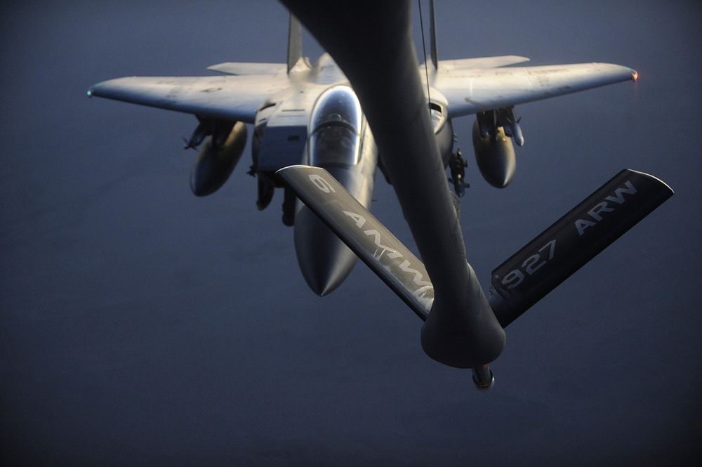 A U.S. Air Force F-15 Strike Eagle aircraft maneuvers into position to receive fuel from a KC-135 Stratotanker aircraft over…