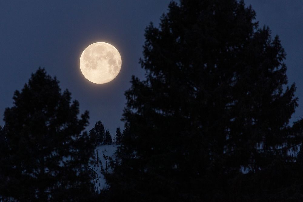 Full moon sets over ridge of Sepulcher Mountain. Original public domain image from Flickr