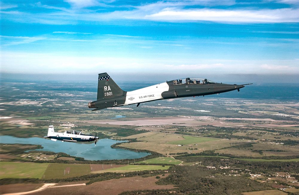 OVER LACKLAND AIR FORCE BASE, Texas -- T-6A Texan II and T-38 Talon participate in the 2004 Lackland Airfest, in San…