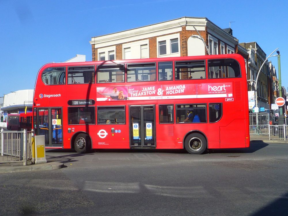 London buses with signage on the passenger doors telling passengers that the doors close to the bus driver at the front of…