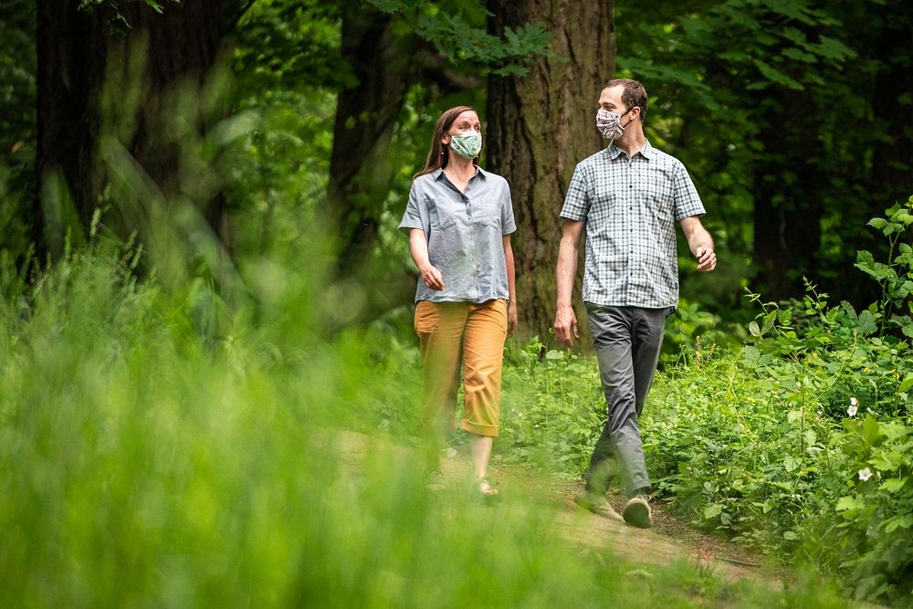 Couple with face coverings walking in nature, Oregon. Original public domain image from Flickr