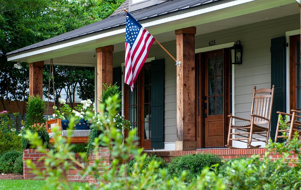 American flag hanging on house facade. Free public domain CC0 photo.