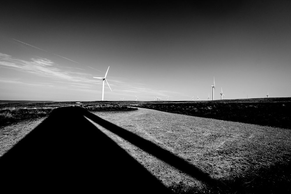 Wind turbine and shadow in monotone. Original public domain image from Flickr