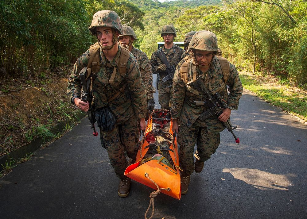 190612-N-TH560-0735 CAMP GONSALVES, Okinawa (June 12, 2019) Hospital Corpsmen transport a simulated wounded patient to a…