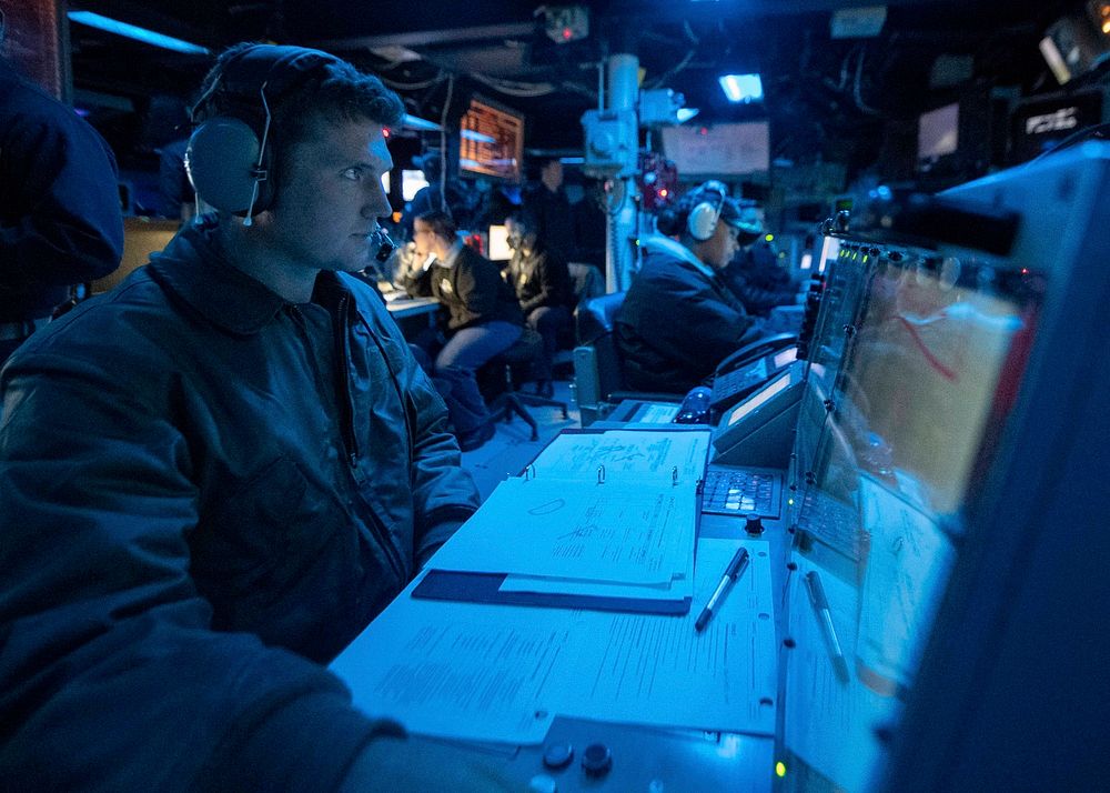 ATLANTIC OCEAN (Oct. 14, 2020) Lt. Cmdr. Shawn Henry operates a console in the Combat Information Center aboard the Arleigh…