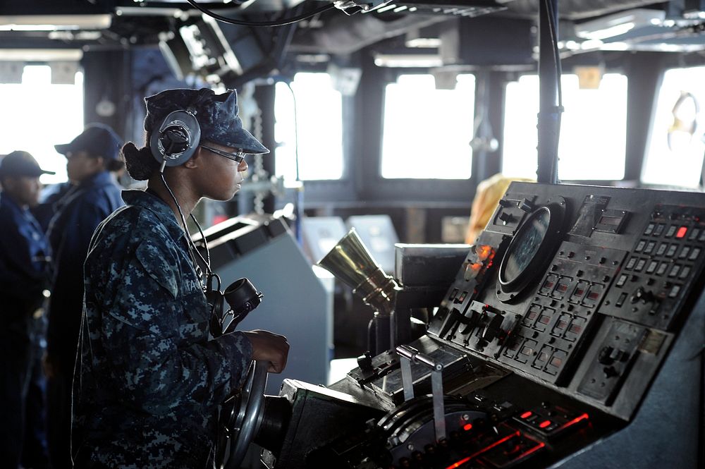 U.S. Navy Seaman Rachel Mackey steers the amphibious dock landing ship USS Harpers Ferry (LSD 49) through the Philippine Sea…