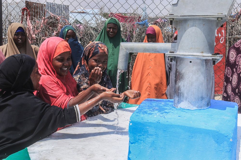 Girls drink water from rehabilitated wells by AMISOM in EL-Ma'an, Bal'ad District of HirShabelle State.