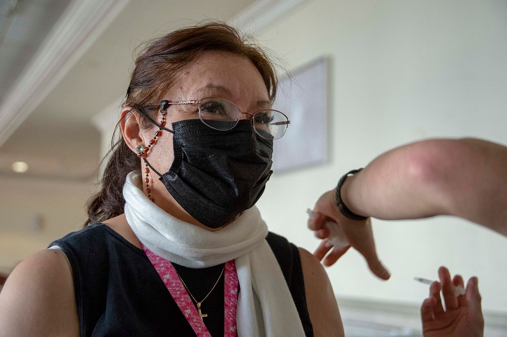 210202-N-LW757-1038 SAN DIEGO (Feb. 2, 2021) Teresa Cofer receives the coronavirus (COVID-19) vaccine on board Naval Base…