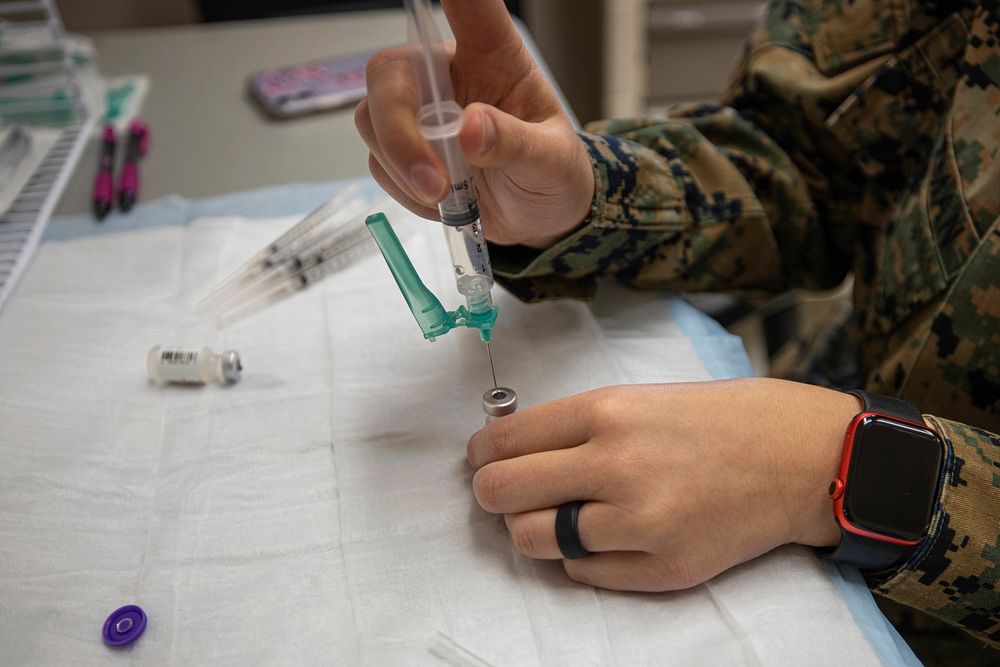 CAMP PENDLETON, Calif. (March 11, 2021) A U.S. Navy Corpsman draws a COVID-19 vaccine from a vial during a SHOTEX at Camp…