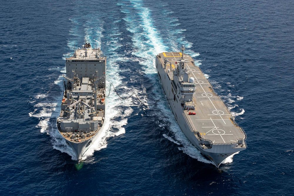 ATLANTIC OCEAN (April 20, 2021) The French Navy mistral-class amphibious assault ship FS Dixmude (L9015), right, conducts a…
