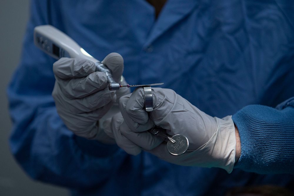 SOUTH CHINA SEA (April 6, 2021) – U.S. Navy Lt. John Miller, a dentist, from Seal Beach, Calif., holds a rotary file aboard…