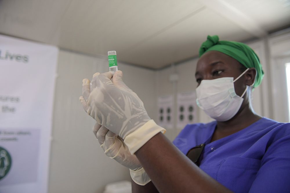 A medical officer serving under the African Union Mission in Somalia (AMISOM) prepares to administer the COVID-19 vaccine at…
