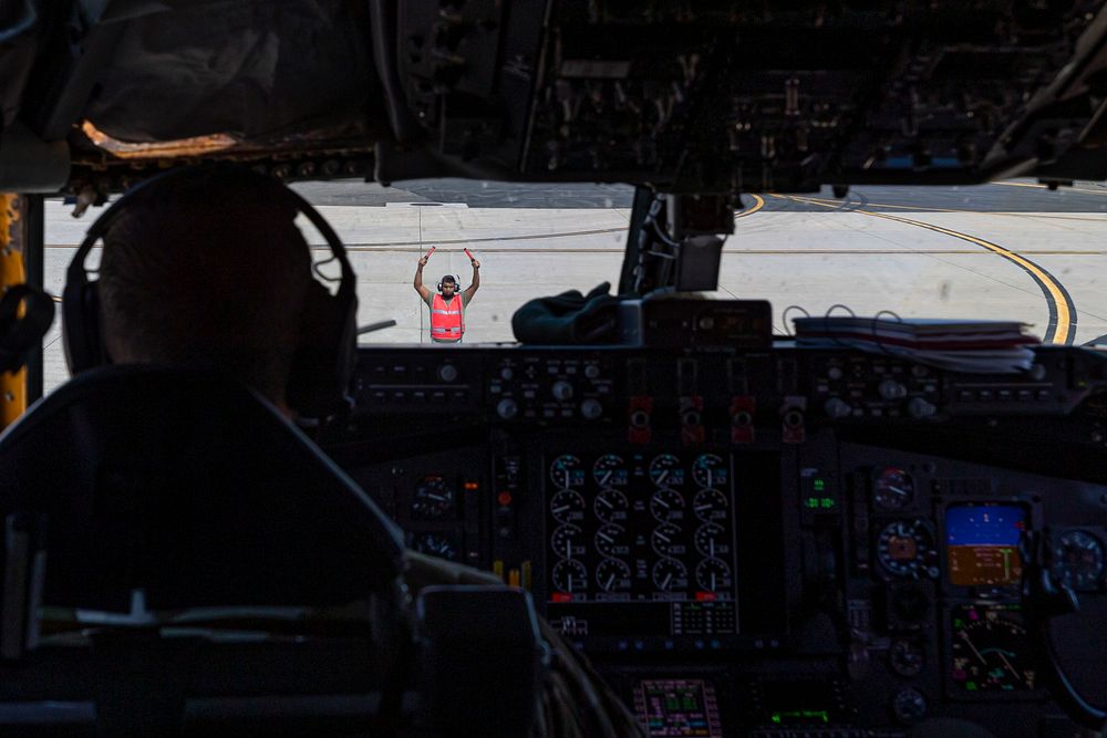 A U.S. Air Force Airman with the 108th Wing marshalls in a KC-135R Stratotanker after a training mission on Joint Base…