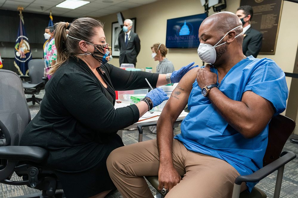 Nurse vaccinator Denise Boehm administers a COVID-19 vaccine to U.S. Army Staff Sgt. Marvin Cornish during a briefing on the…