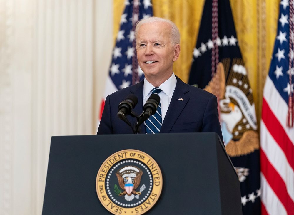 President Joe Biden smiles during his first official press conference Thursday, March 25, 2021, in the East Room of the…